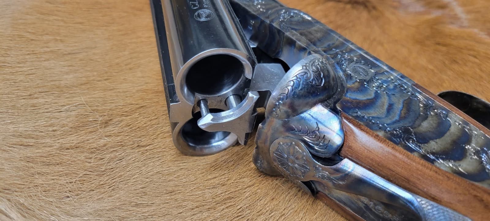 Side-by-side coach gun broken open on the bench for cowboy action shotgun service at Custom Gunworks