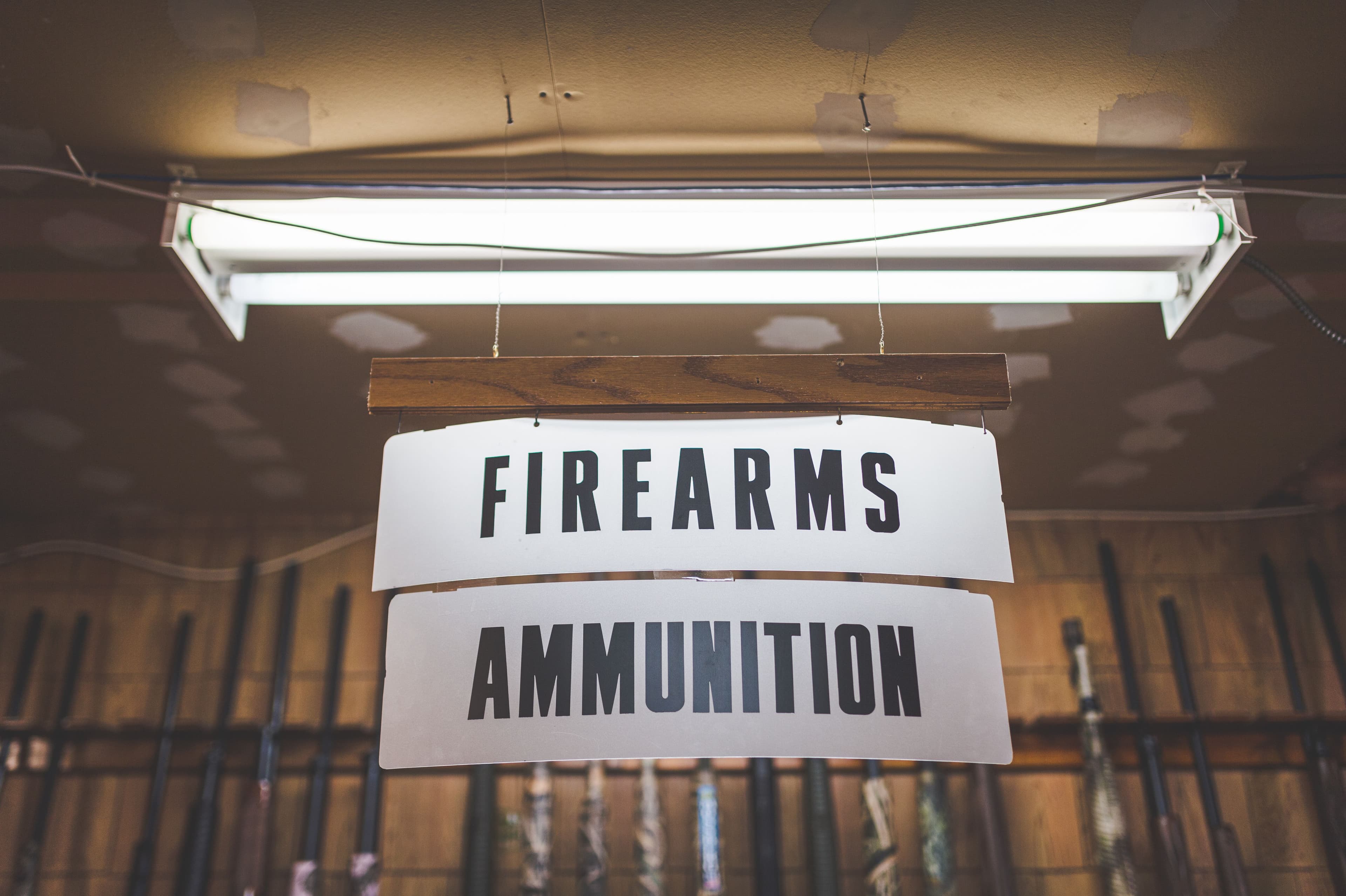 Hanging firearms and ammunition sign inside a gun shop.