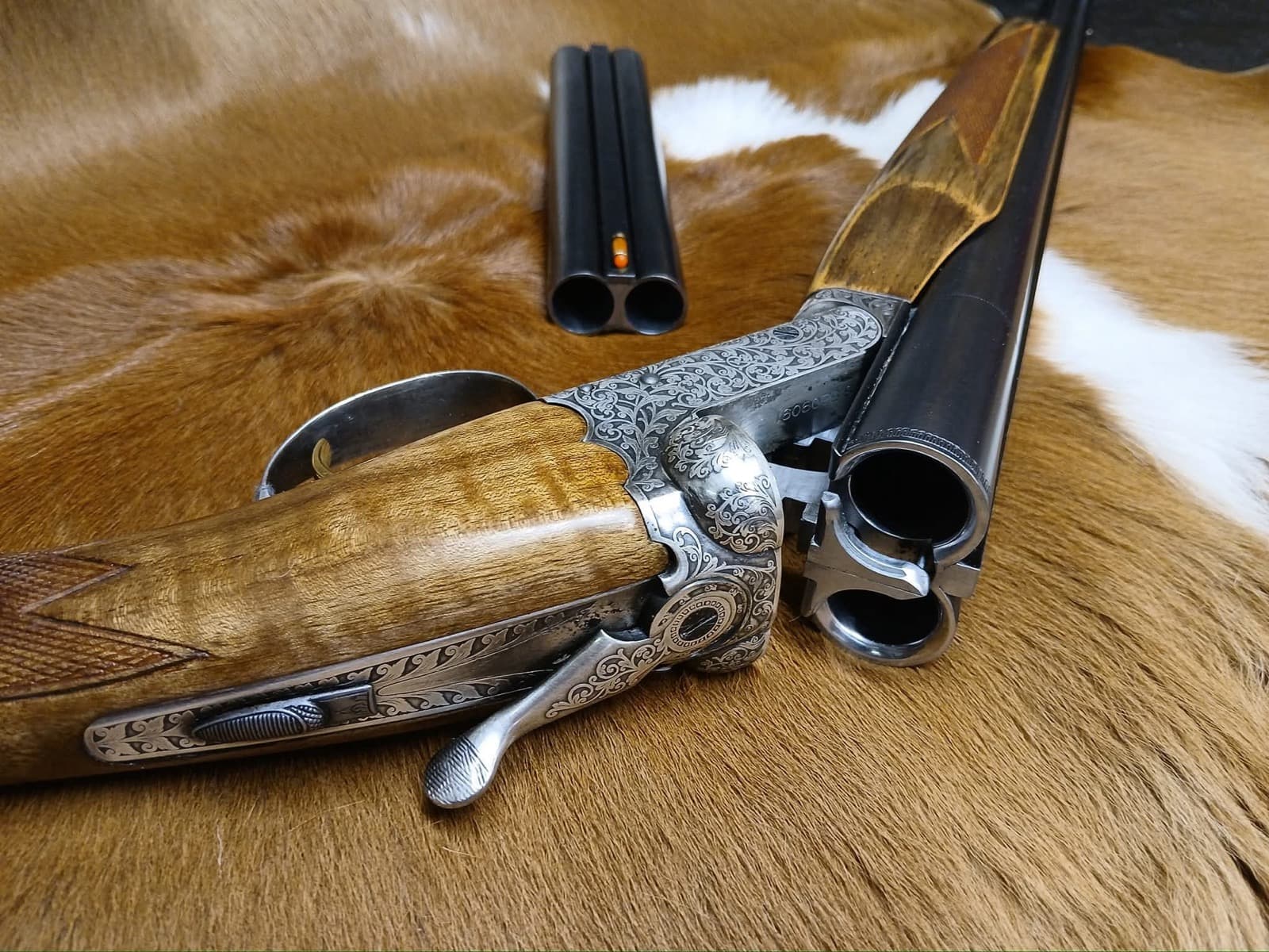 Engraved double-barrel shotgun used for cowboy action gunsmithing at Custom Gunworks