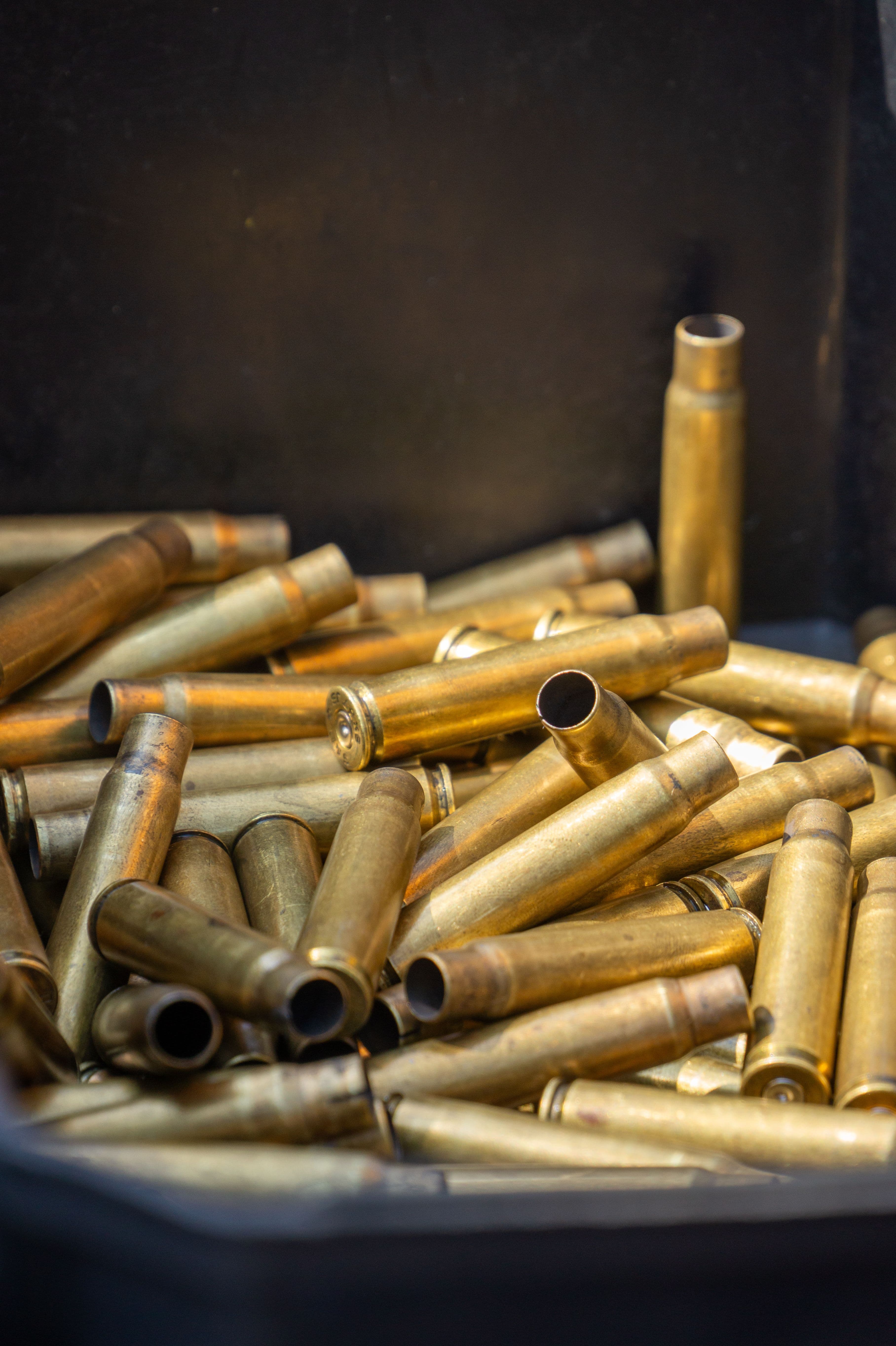 A pile of spent brass cartridge casings catching the light.